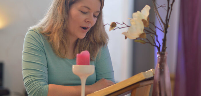 Layperson reading aloud from the Bible in front of the congregation