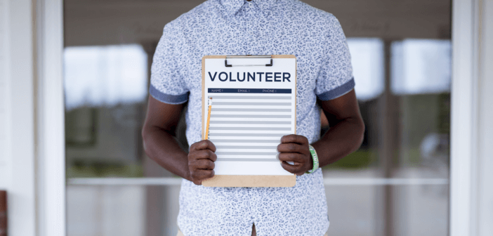 Person holding a volunteer sign-up sheet