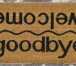 Floor mat that reads goodbye on one side and welcome on the other