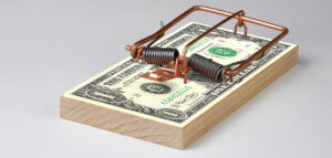 Mouse trap on a stack of cash bills