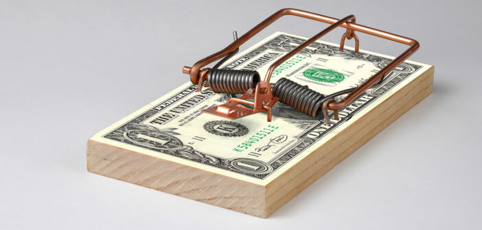 Mouse trap on a stack of cash bills