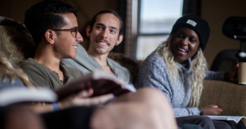 Young adults on a couch having Bible study