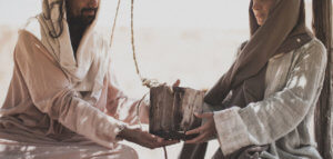 The Samaritan woman giving Jesus a drink of water from the well.