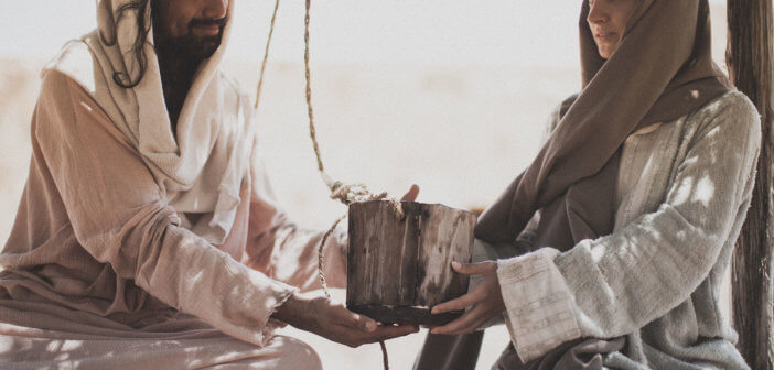 The Samaritan woman giving Jesus a drink of water from the well.