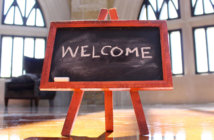 7 Suggestions for Welcoming New Pastors Easel with WELCOME written in chalk in a church sanctuary