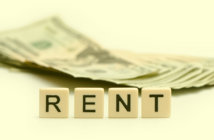 Before You Rent Church Space, Calculate the Costs R E N T spelled out on tiles in front of a stack of cash