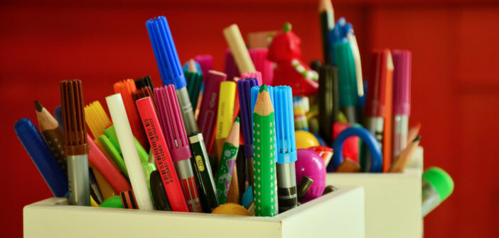 Box overflowing with colored pencils and markers