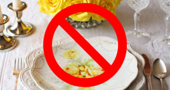 Fancy place setting of fine china with a DO NOT symbol superimposed