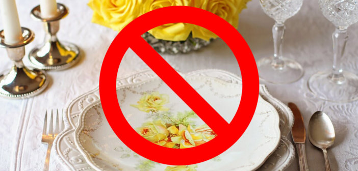 Fancy place setting of fine china with a DO NOT symbol superimposed