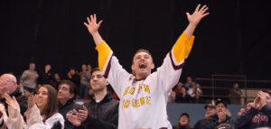 Very excited fan cheering at a hockey game