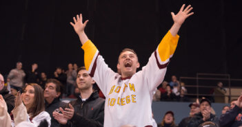 Very excited fan cheering at a hockey game