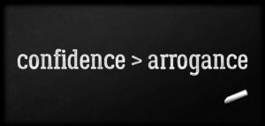 confidence > arrogance written in chalk