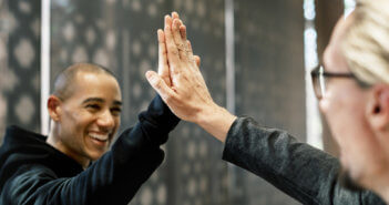 Smiling people giving each other a high five