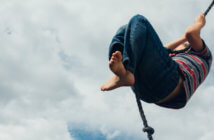 Take a Risk This Stewardship Season Person high on a rope swing
