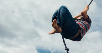 Person high on a rope swing