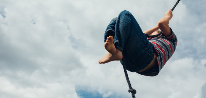 Person high on a rope swing