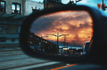 3 Strategies for Leading Beyond Your Blind Spots View from the passenger seat of a car of the driver's side mirror