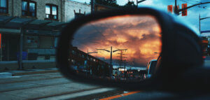 View from the passenger seat of a car of the driver's side mirror