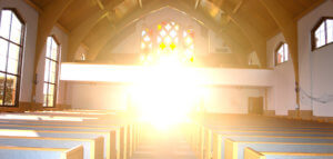 Interior of a church with beautiful, hopeful sunshine streaming in