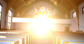 Interior of a church with beautiful, hopeful sunshine streaming in