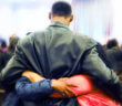 A person receiving hugs in a church sanctuary