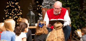Reading to young children at Christmas Eve service