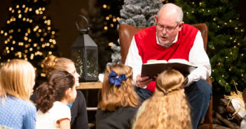 Reading to young children at Christmas Eve service