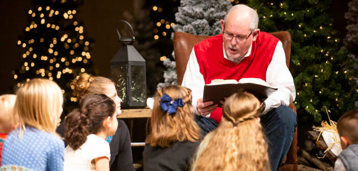 Reading to young children at Christmas Eve service