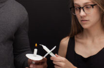 Will Your Christmas Visitors Feel Celebrated or Shamed? Tentative looking person passing candlelight at a Christmas Eve service