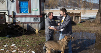 Wayne Worth (right) embraces Roger outside his home in Fisher, W.Va. Worth, a member of United Methodist Temple in Clarksburg, was passing out flyers containing information about local resources for anyone struggling with addiction when he met Roger. Photo by Mike DuBose, UM News.