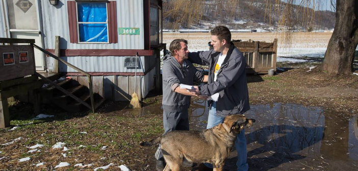 Wayne Worth (right) embraces Roger outside his home in Fisher, W.Va. Worth, a member of United Methodist Temple in Clarksburg, was passing out flyers containing information about local resources for anyone struggling with addiction when he met Roger. Photo by Mike DuBose, UM News.