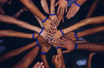 6 Leadership Practices that Enhance Involvement and Collaboration Group of people in a happy huddle