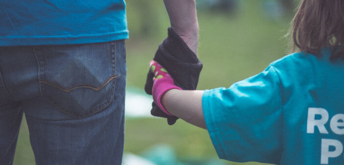 Adult holding a child's hand