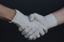 Shaking hands while wearing medical gloves