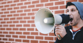 Person shouting into a bullhorn