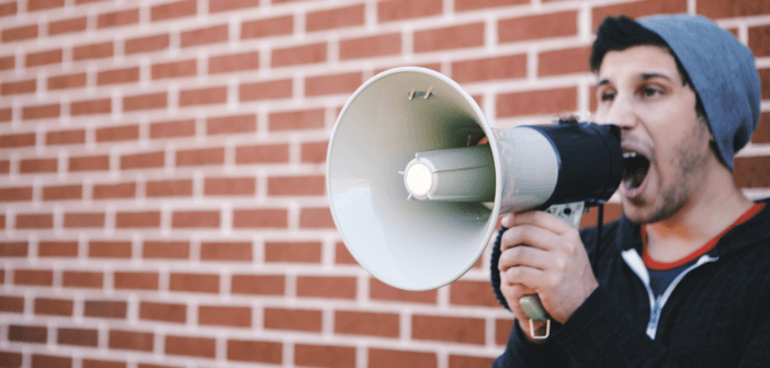 Person shouting into a bullhorn