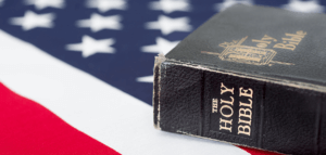Time-worn Bible resting upon an American flag