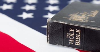 Time-worn Bible resting upon an American flag