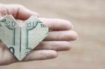 Changing the Tone of Conversations about Money and Church $50 bill folded into an origami heart in the open palm of a person's hand