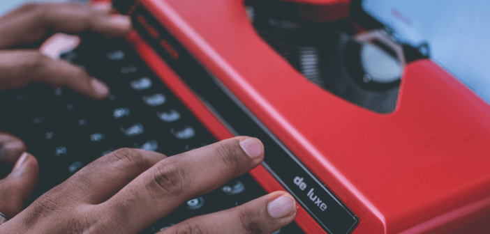 Hands typing on a typewriter