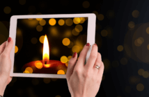 11 Creative Ways Your Church Can Observe Christmas in 2020 Christmas candle on the screen of a tablet computer
