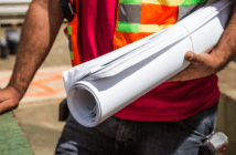 When Churches Engage the World of Business Construction person holding rolled-up drafting papers