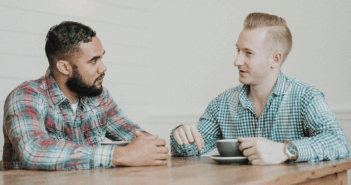 2 people having a conversation over coffee