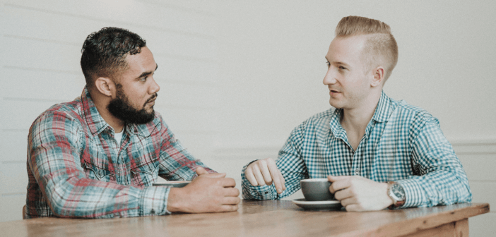 2 people having a conversation over coffee