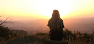 Person taking in a beautiful sunrise