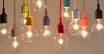 Many smaller lit lightbulbs hanging from colored cords