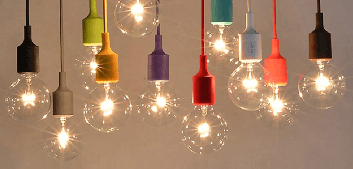 Many smaller lit lightbulbs hanging from colored cords