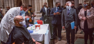 Dr. Fauci watches as a clergy member receives their vaccination at an event at Washington National Cathedral - https://cathedral.org/