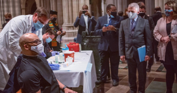 Dr. Fauci watches as a clergy member receives their vaccination at an event at Washington National Cathedral - https://cathedral.org/