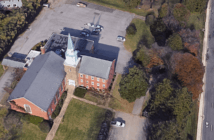 Leveraging Church Property Can Sustain Your Mission Bird's eye view of a church with a large empty parking lot beside a busy road